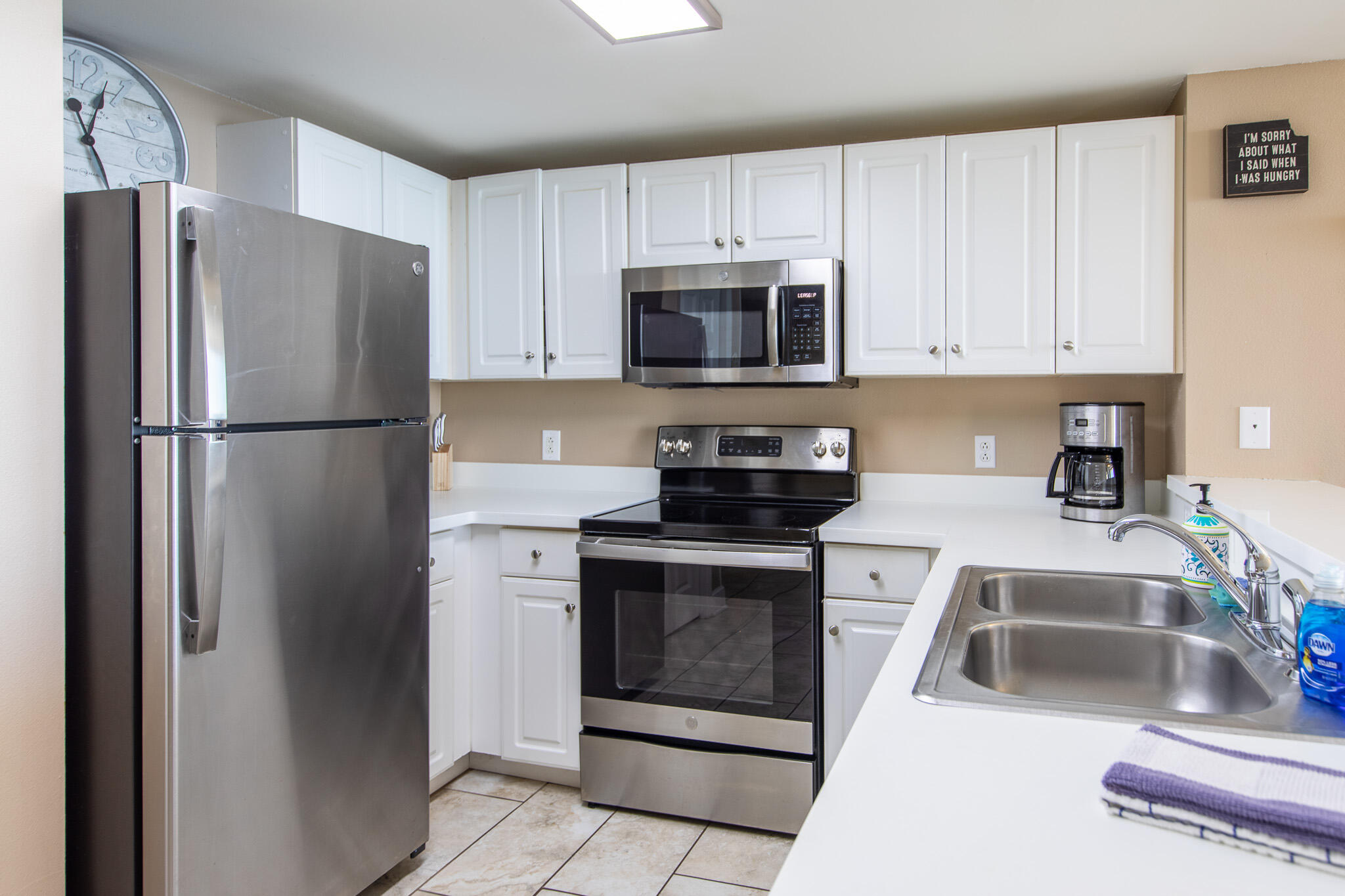 10901 Front Beach Road, Unit 2103 Panama City Beach, FL 32408 - Photo 16 of 54 a kitchen with stainless steel appliances granite countertop a refrigerator sink and stove