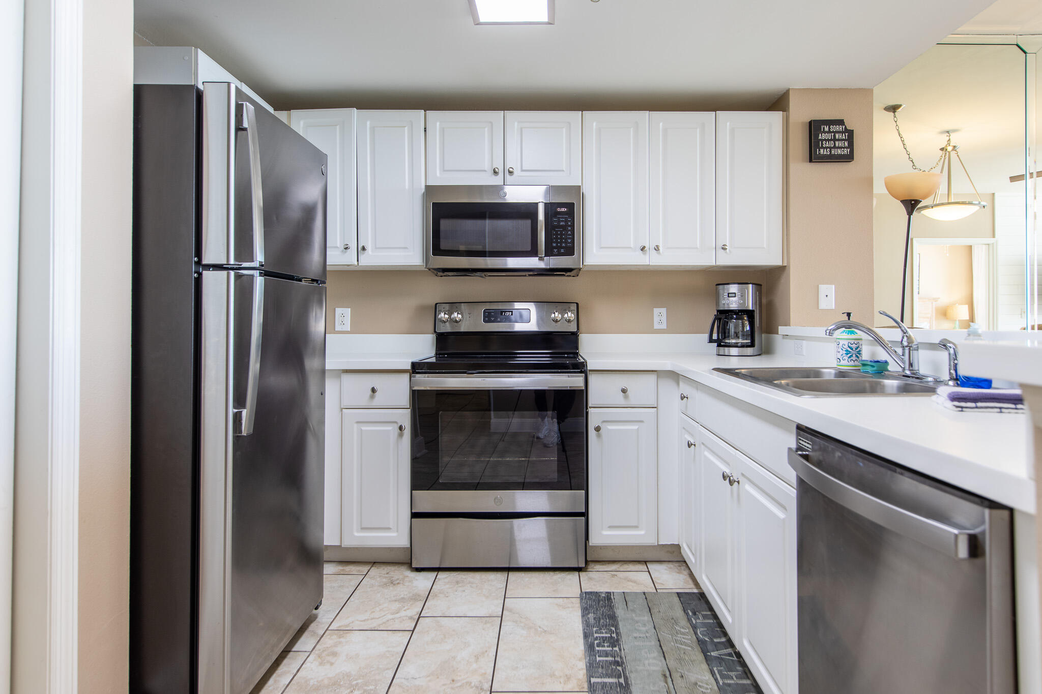 10901 Front Beach Road, Unit 2103 Panama City Beach, FL 32408 - Photo 17 of 54 a kitchen with a refrigerator stove and microwave