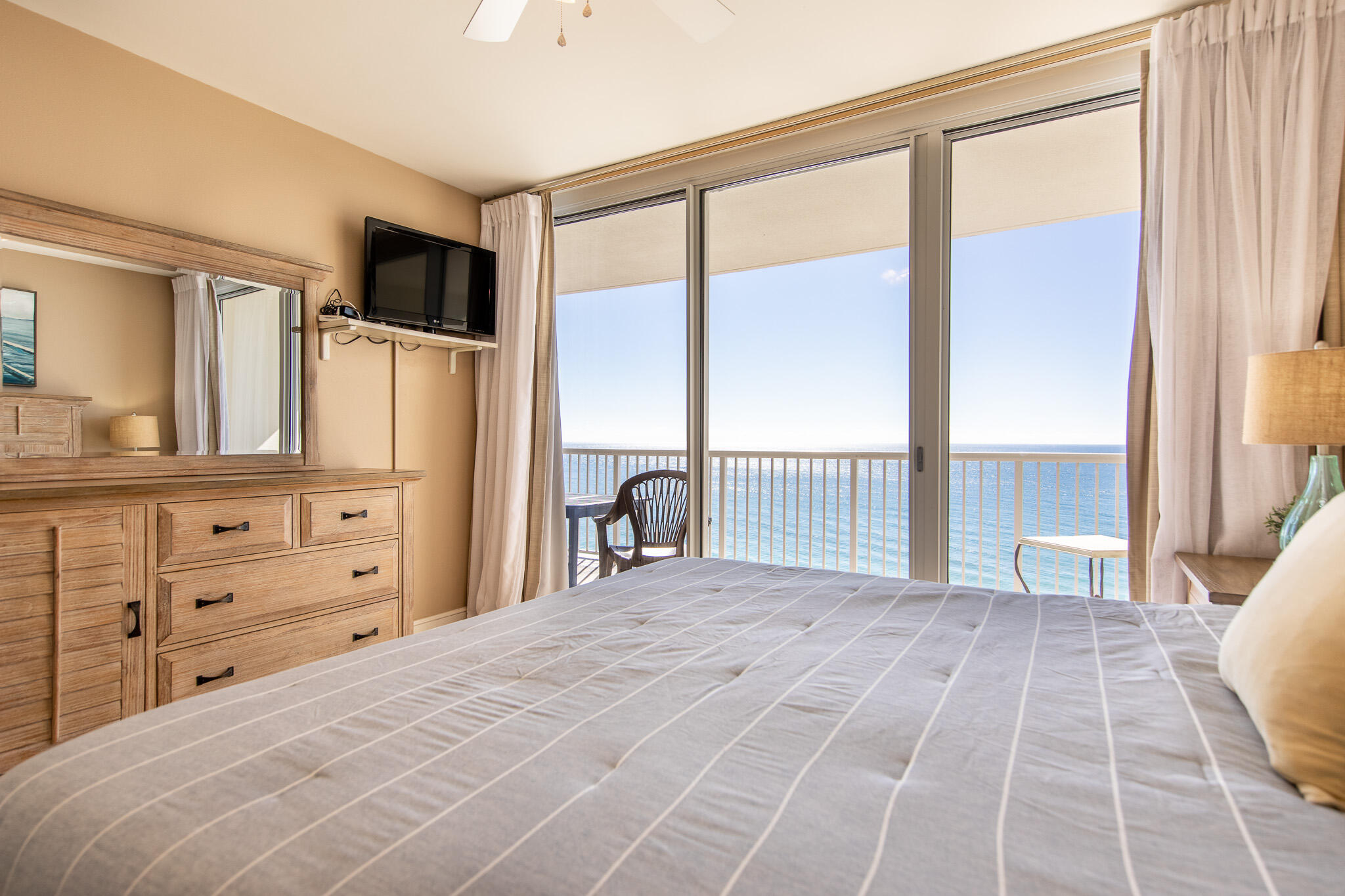 10901 Front Beach Road, Unit 2103 Panama City Beach, FL 32408 - Photo 20 of 54 a large bedroom with a large bed and a large window with balcony view
