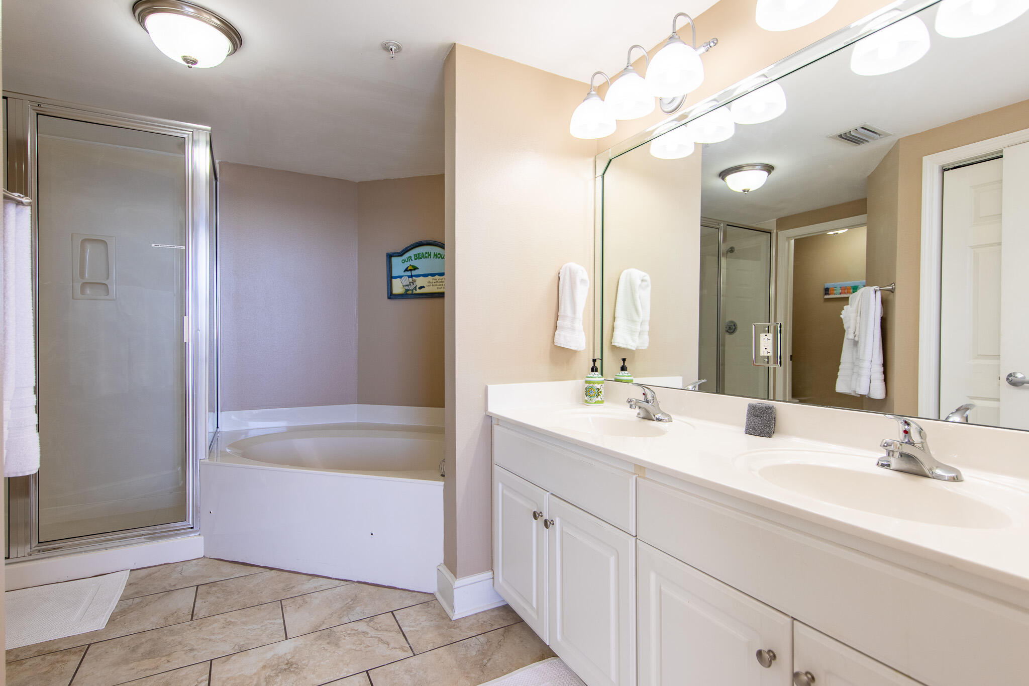 10901 Front Beach Road, Unit 2103 Panama City Beach, FL 32408 - Photo 22 of 54 a bathroom with a bathtub sink and mirror