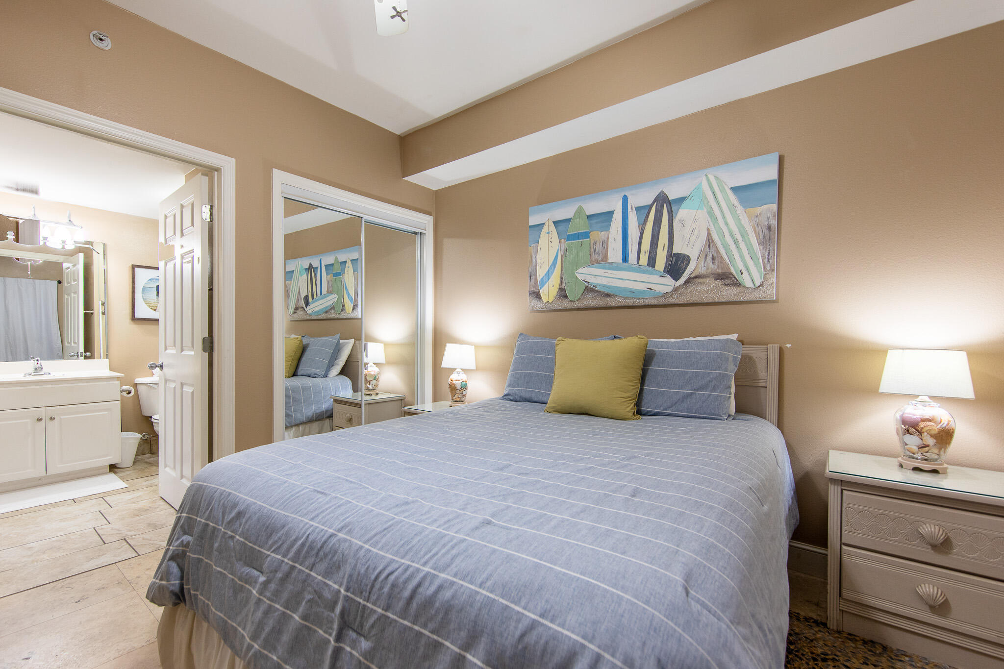 10901 Front Beach Road, Unit 2103 Panama City Beach, FL 32408 - Photo 26 of 54 a bedroom with a large bed and a chandelier