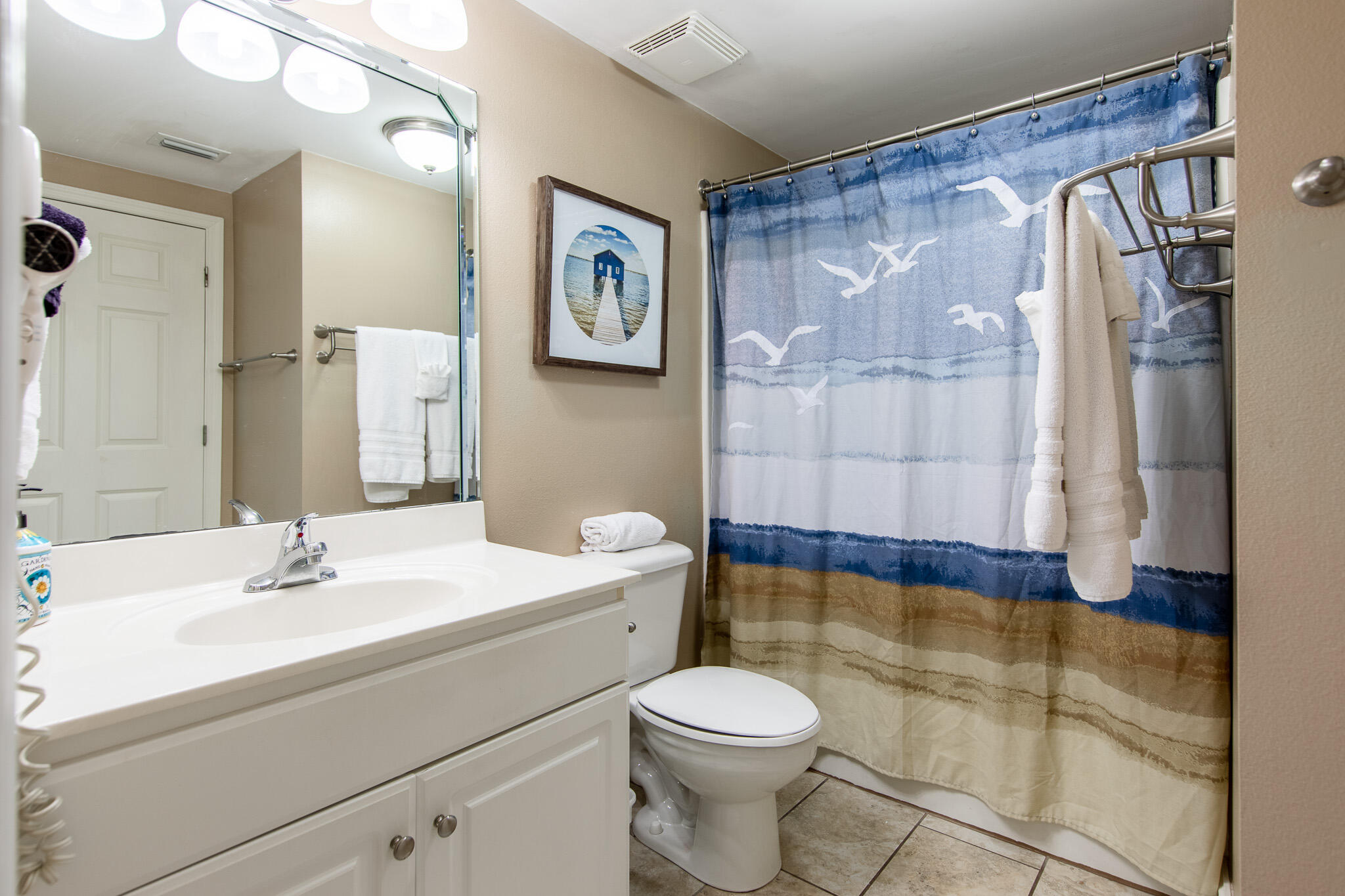 10901 Front Beach Road, Unit 2103 Panama City Beach, FL 32408 - Photo 27 of 54 a bathroom with a sink a toilet and shower