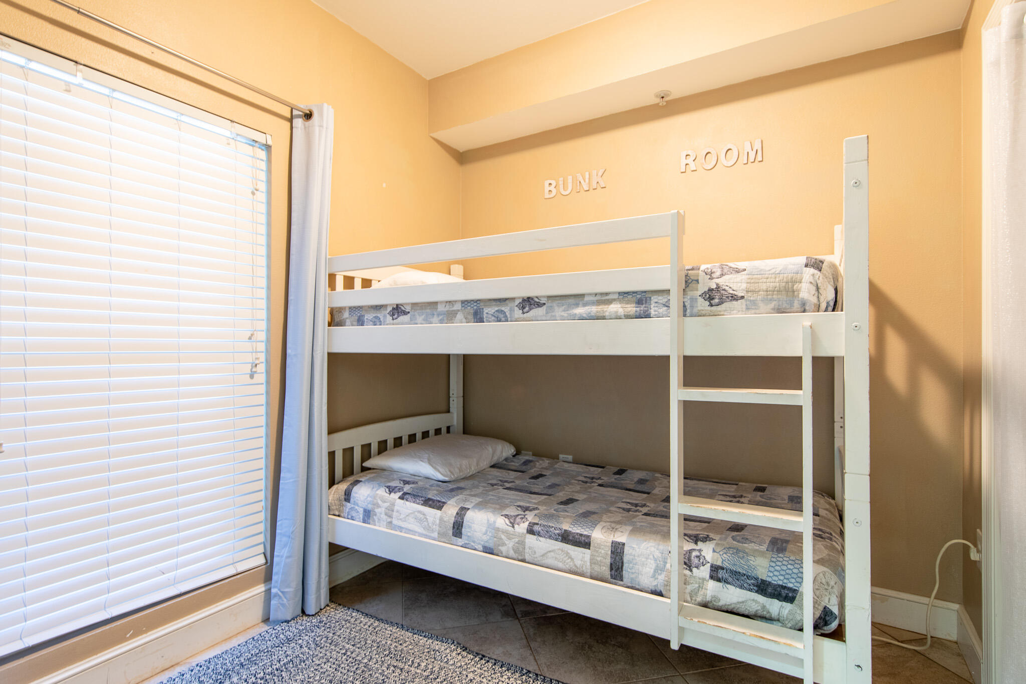 10901 Front Beach Road, Unit 2103 Panama City Beach, FL 32408 - Photo 28 of 54 a bedroom with a bed and a window