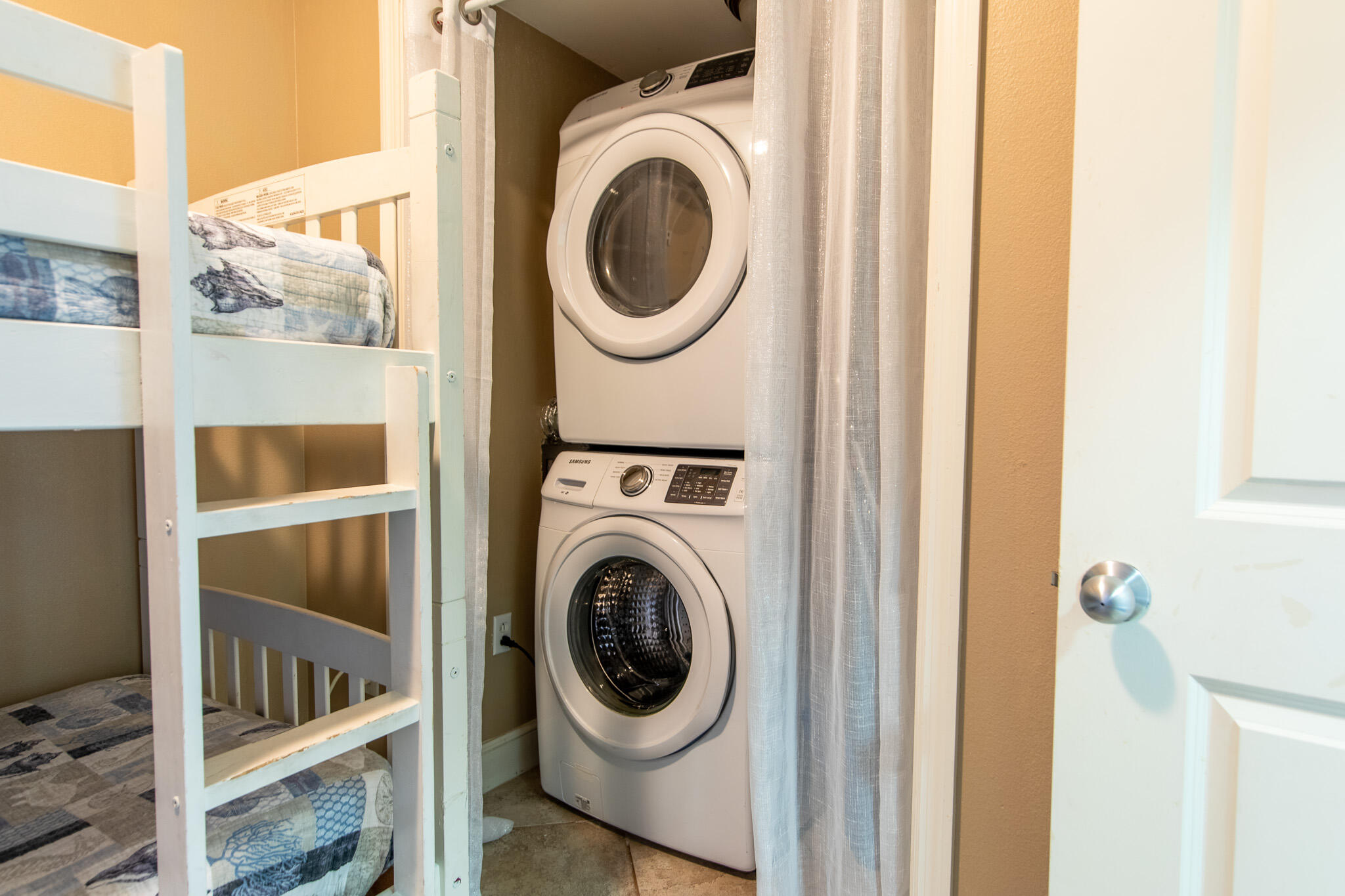 10901 Front Beach Road, Unit 2103 Panama City Beach, FL 32408 - Photo 30 of 54 a utility room with dryer and washer