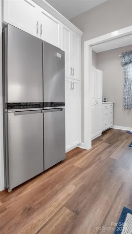 a living room with furniture a window and a flat screen tv