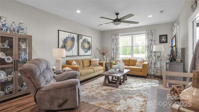 a living room with patio furniture and a floor to ceiling window