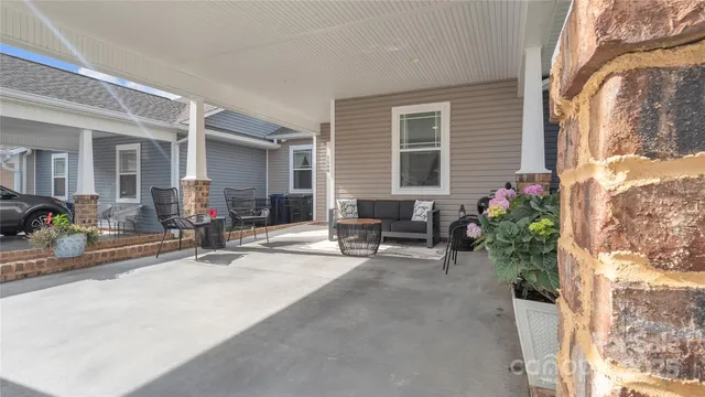 a kitchen with granite countertop white cabinets stainless steel appliances and wooden floor