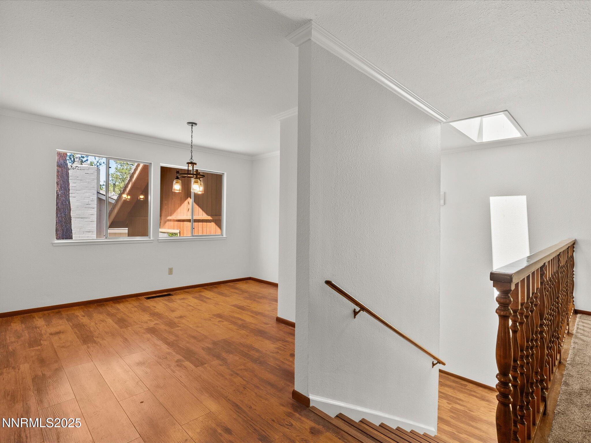 5 Ute Court Stateline, NV 89449 - Photo 12 of 59 a view of an empty room with wooden floor and a window