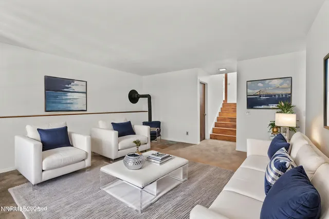 an aerial view of a house with a yard balcony and trees