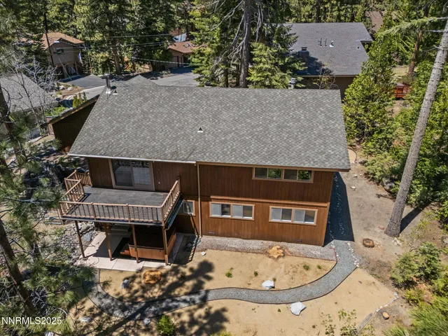 an aerial view of a house with a yard and sitting area