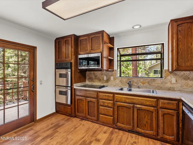 a bedroom with a bed flat screen tv and window