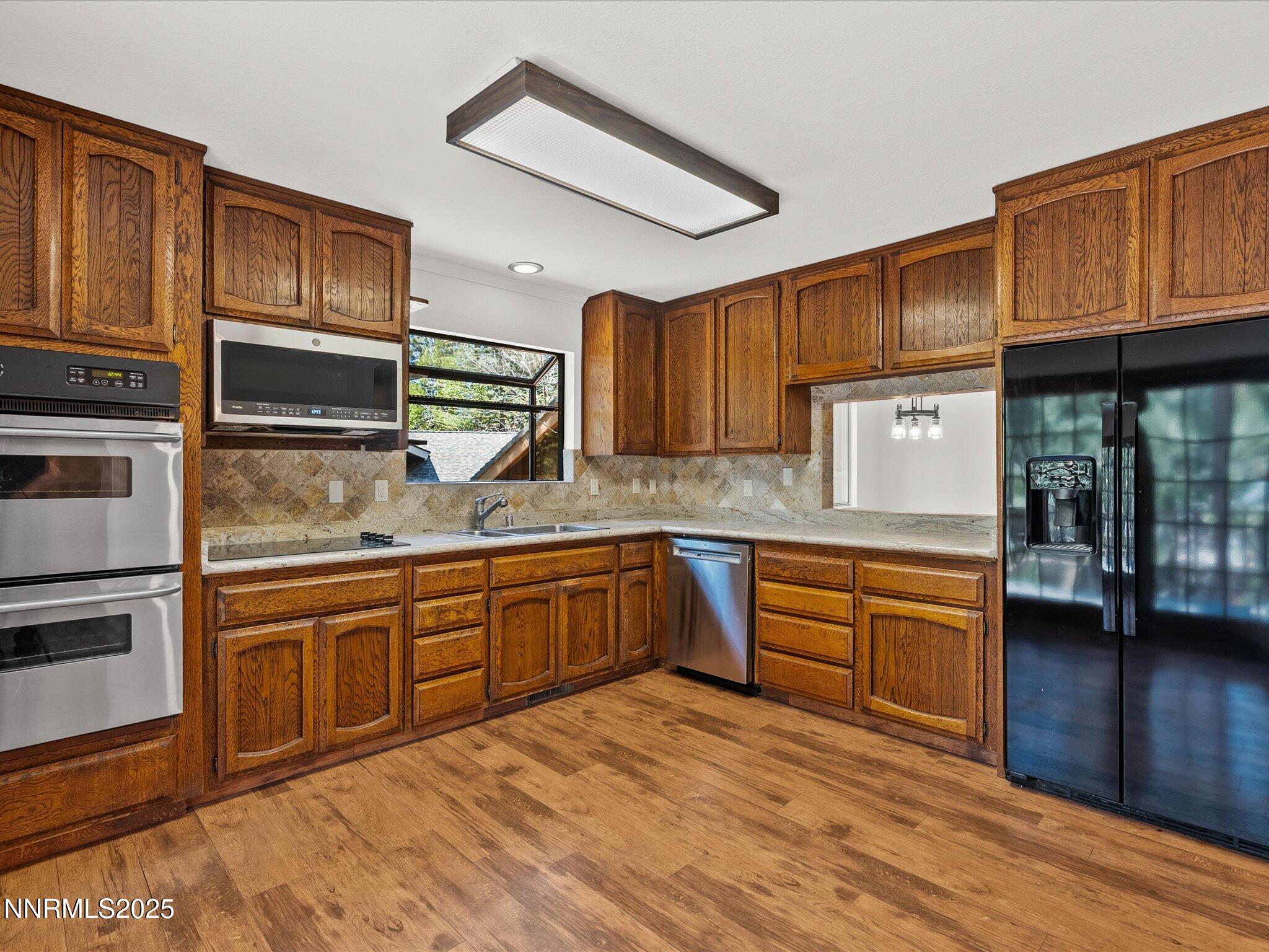 5 Ute Court Stateline, NV 89449 - Photo 10 of 59 a kitchen with stainless steel appliances granite countertop a sink and wooden cabinets
