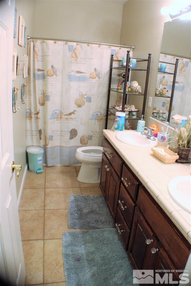 10558 Crystal Bay Drive Reno, NV 89521 - Photo 12 of 16 a spacious bathroom with a double vanity sink toilet and a tub