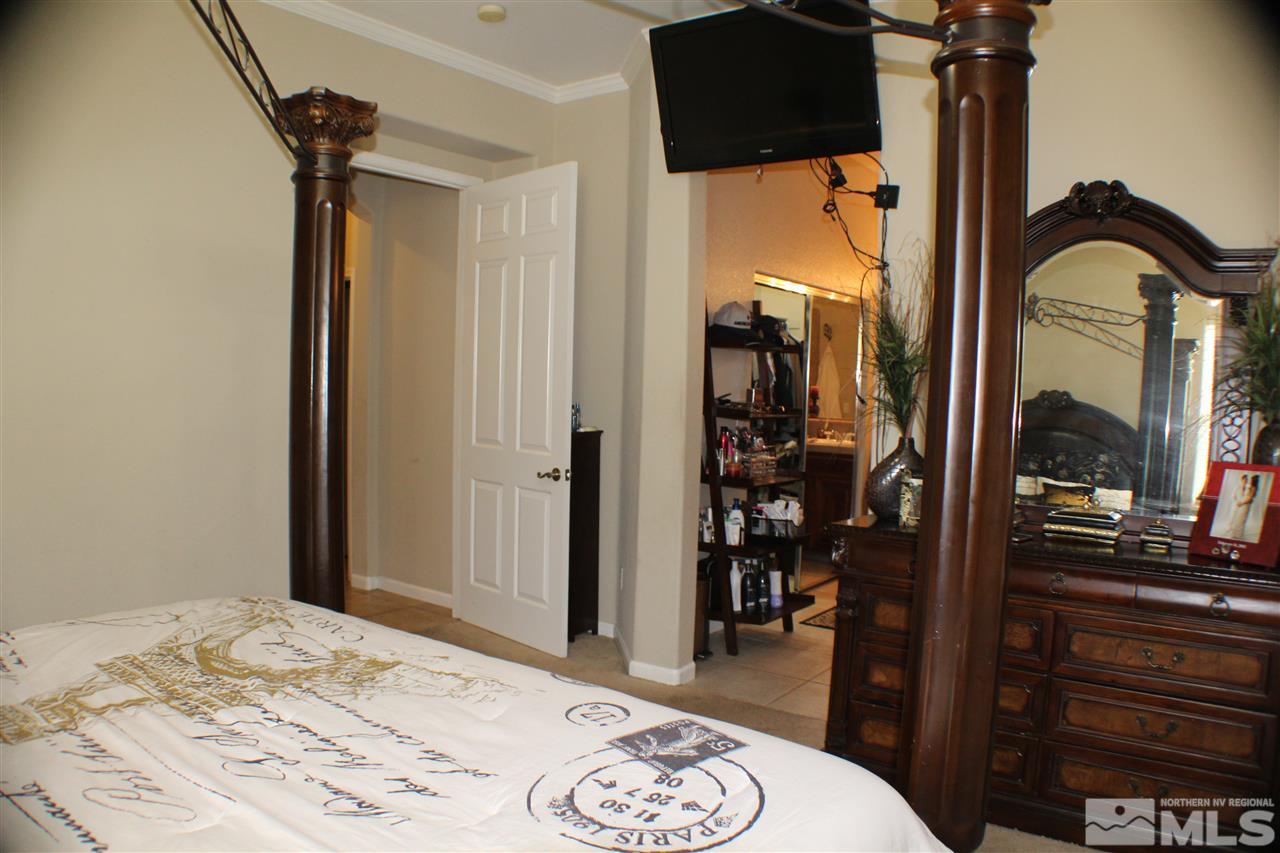 10558 Crystal Bay Drive Reno, NV 89521 - Photo 14 of 16 a bedroom with a bed and a dresser