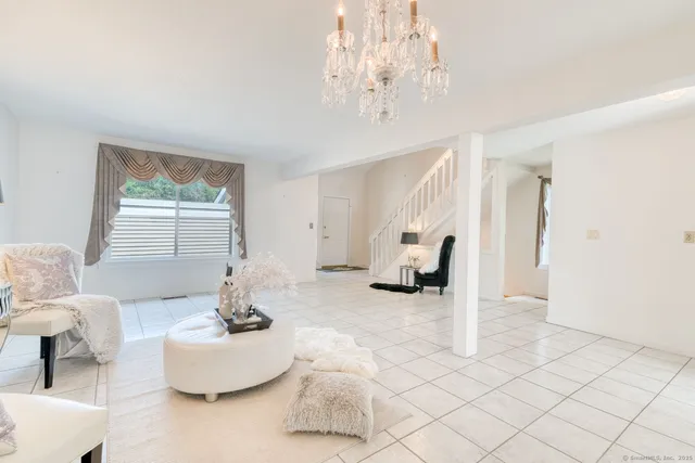 a living room with furniture and a chandelier