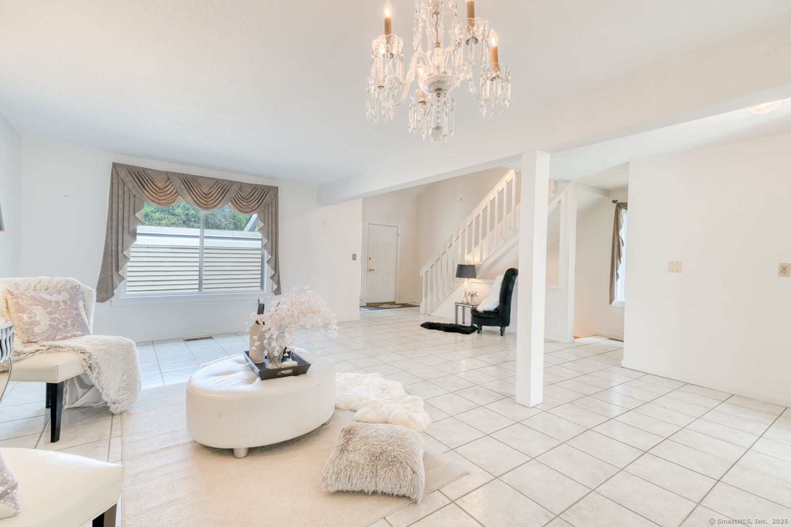 592 Mountain Road, Unit A West Hartford, CT 06117 - Photo 12 of 40 a living room with furniture and a chandelier