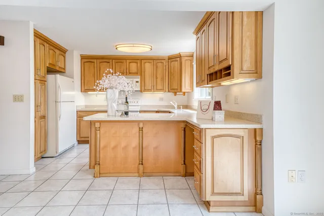 a kitchen with stainless steel appliances granite countertop a refrigerator sink and cabinets