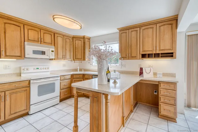a kitchen with a sink stove top oven and cabinets