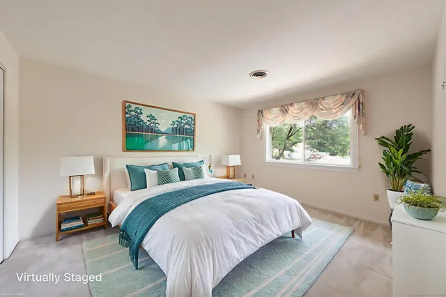 a bed room with a bed and a potted plant