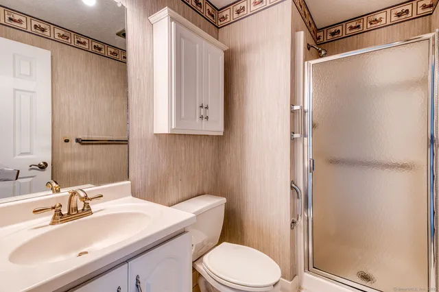 a bathroom with a sink toilet and shower