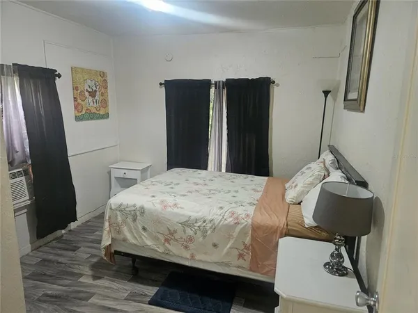 a bedroom with a bed and a mirror