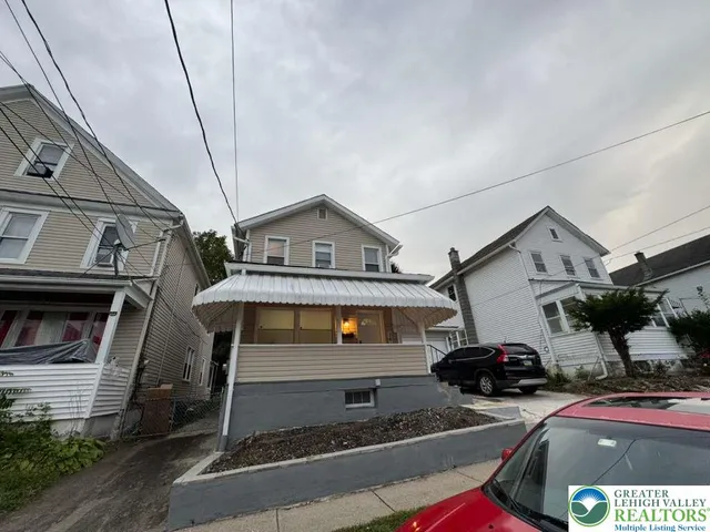 a front view of a house with parking