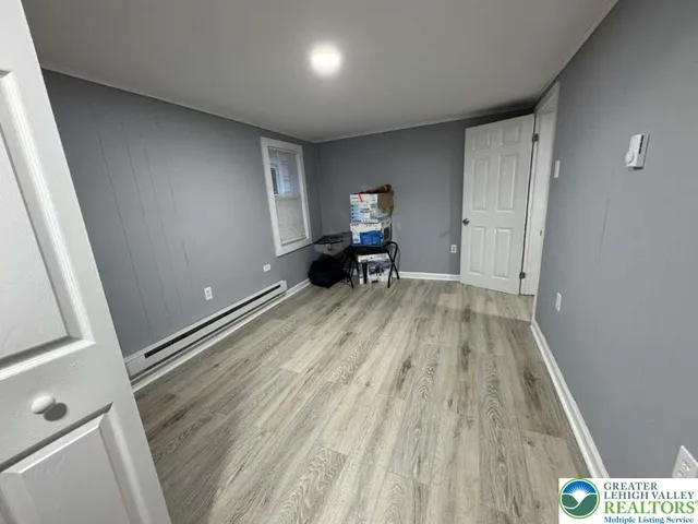 a view of a livingroom with wooden floor and stairs