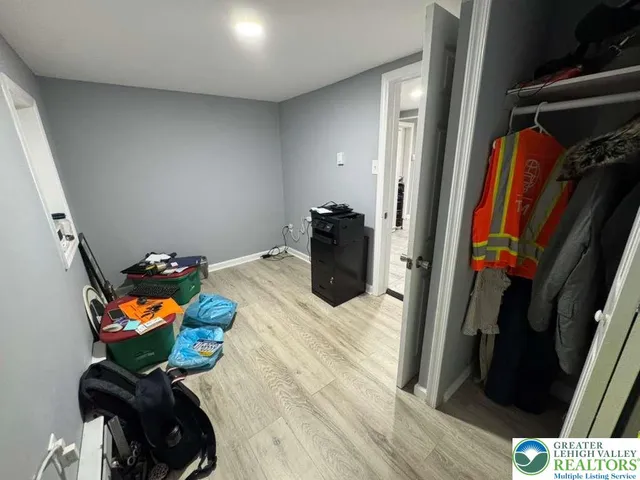 a room with wooden floor and closet