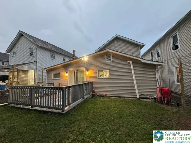 a view of backyard with deck and garden