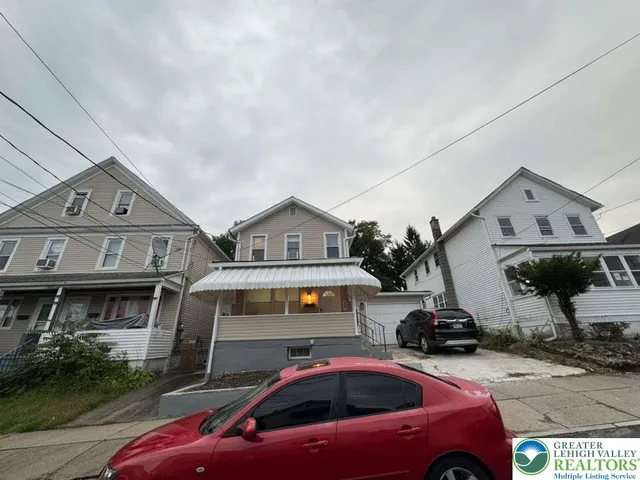 a front view of a house with parking space