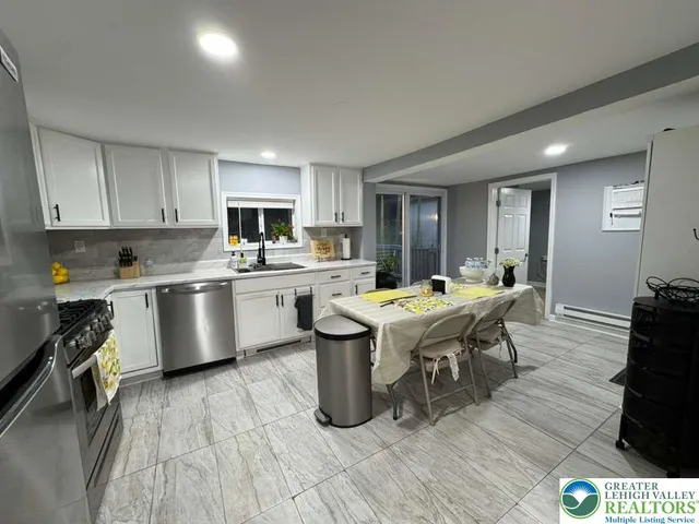 a large kitchen with a table and chairs in it