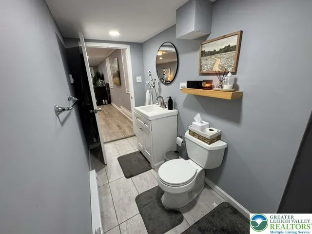 a white toilet sitting next to a bathroom sink