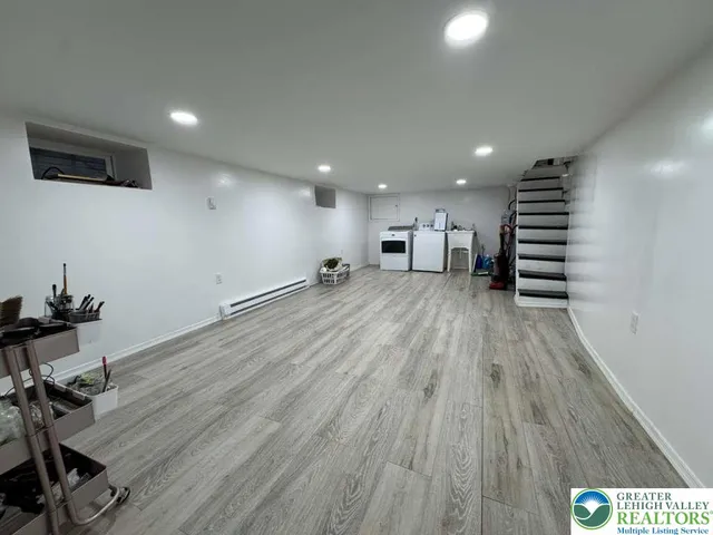 a view of a room with wooden floor and stairs