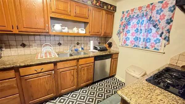 a kitchen with stainless steel appliances granite countertop a sink stove and cabinets