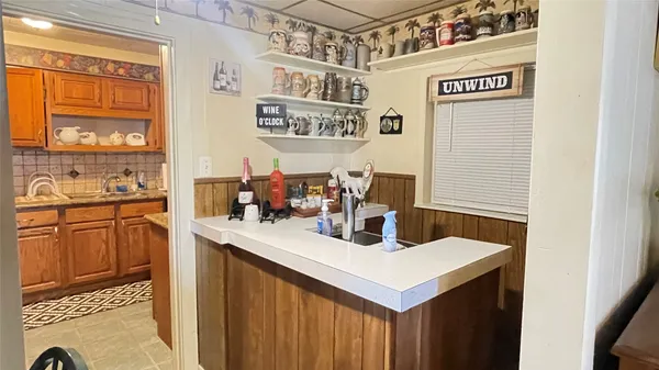a kitchen with a sink cabinets and window