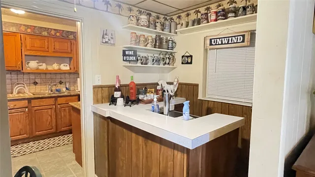 a kitchen with a sink cabinets and window