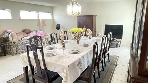 a view of a dining room with furniture and chandelier