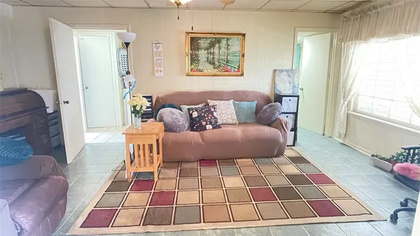 a living room with a couch and a rug