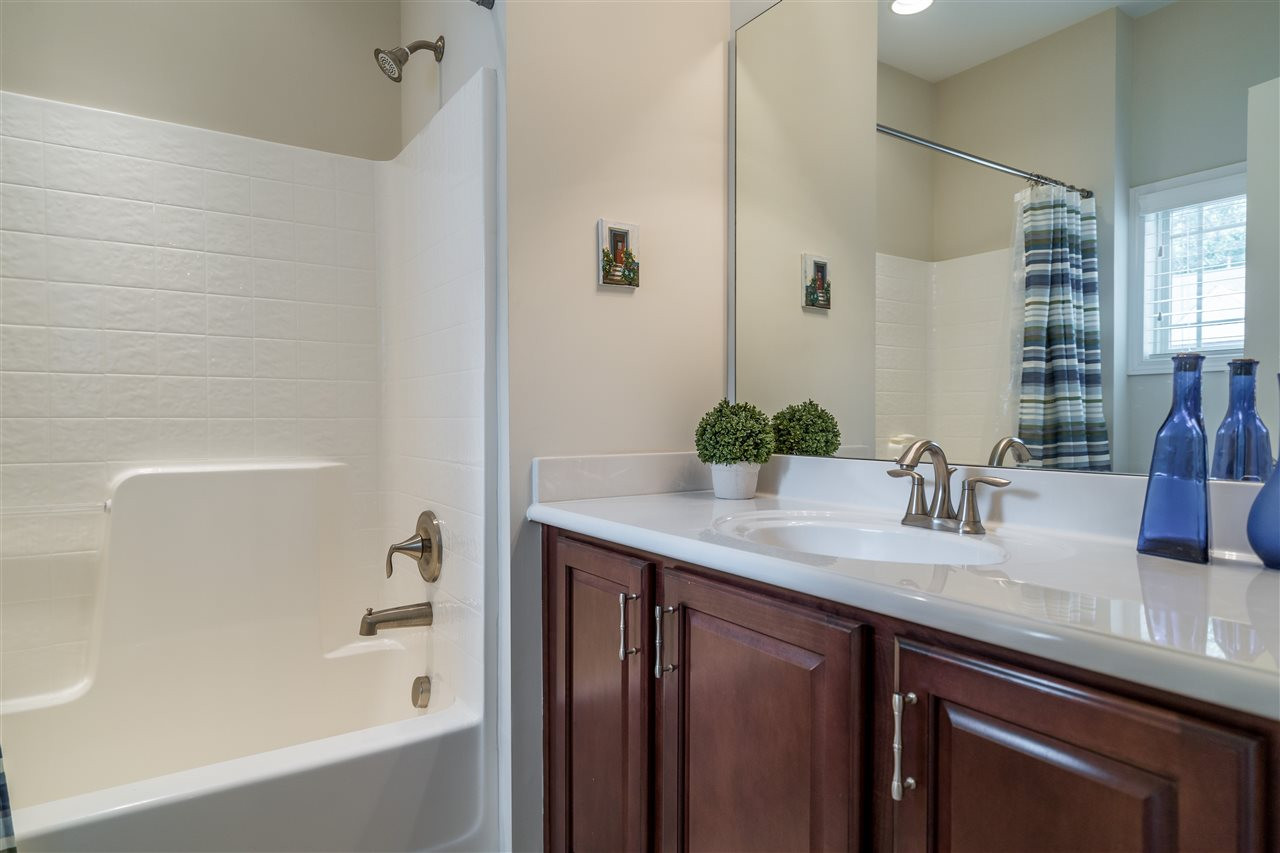 5630 Wade Park Boulevard Raleigh, NC 27607 - Photo 22 of 30 Upstairs shared bathroom for two secondary bedrooms. Ceramic tile, easy to clean shower and coordinating cabinets make this bath stylish and convenient! Bathroom