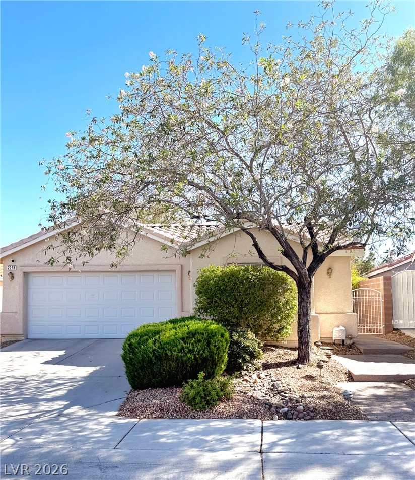 2278 Chestnut Ranch Avenue Henderson, NV 89052 - Photo 1 of 18 A well-maintained facade with a two-car garage, lush landscaping, and a welcoming sidewalk.