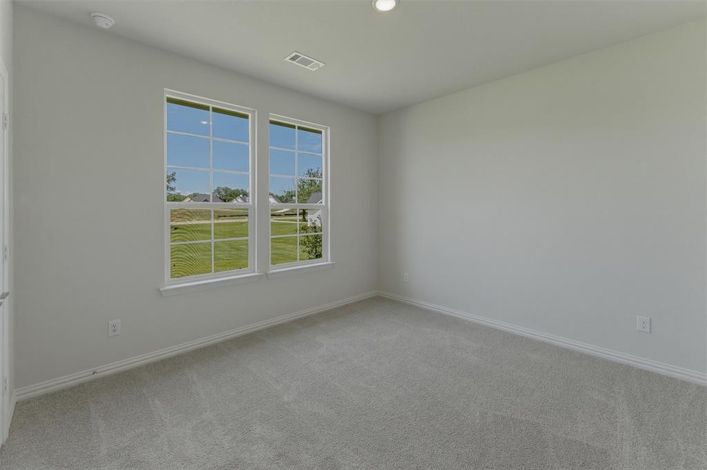 156 Oak Grv Way Springtown, TX 76082 - Photo 14 of 25 Bright room featuring two large windows, neutral gray carpeting, white baseboards, and recessed ceiling lighting