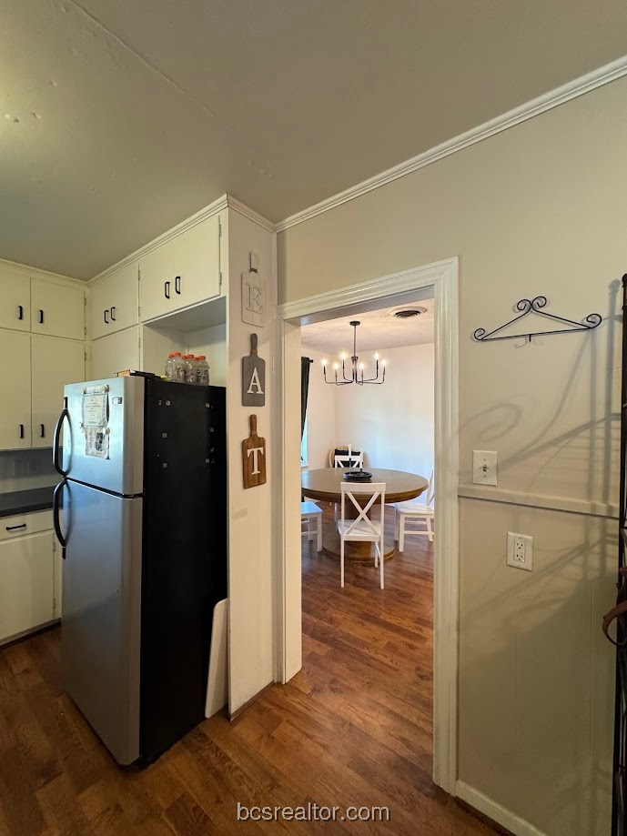 1101 East 30th Street Bryan, TX 77802 - Photo 14 of 42 a kitchen with a refrigerator and a table