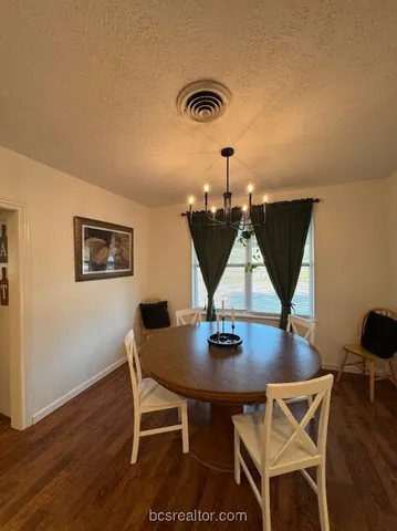 a dining room with wooden floor and breakfast area