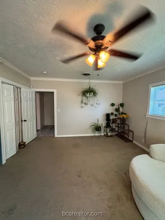a view of an empty room with window and cabinet