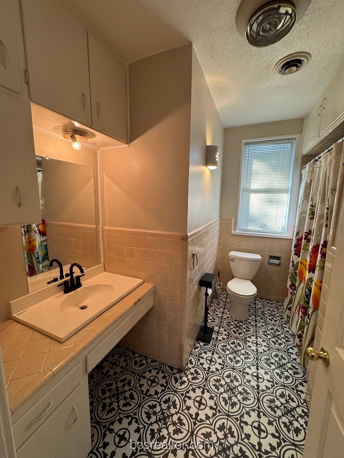 1101 East 30th Street Bryan, TX 77802 - Photo 38 of 42 a bathroom with a sink toilet and shower