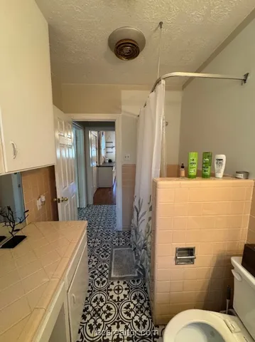 a bathroom with a sink mirror vanity and toilet