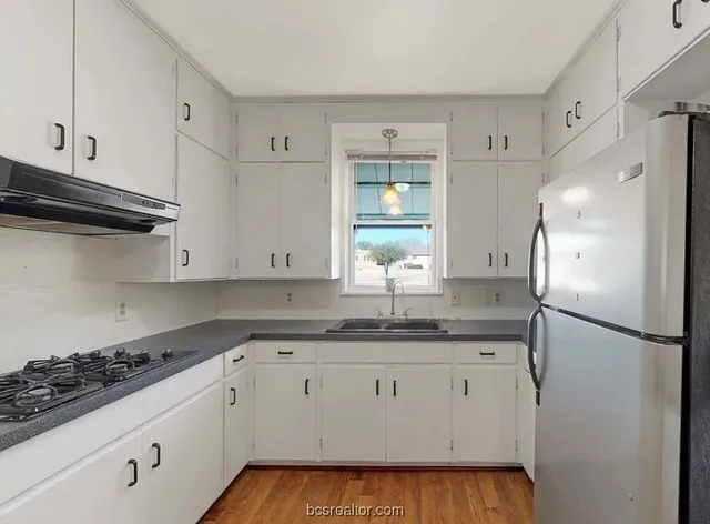 a kitchen with a sink stove and refrigerator