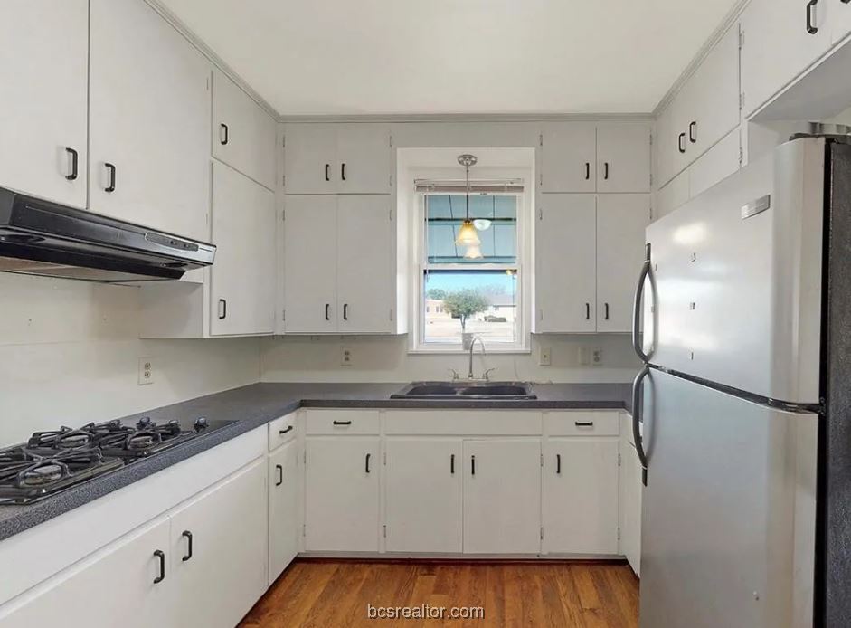 1101 East 30th Street Bryan, TX 77802 - Photo 10 of 42 a kitchen with a sink stove and refrigerator