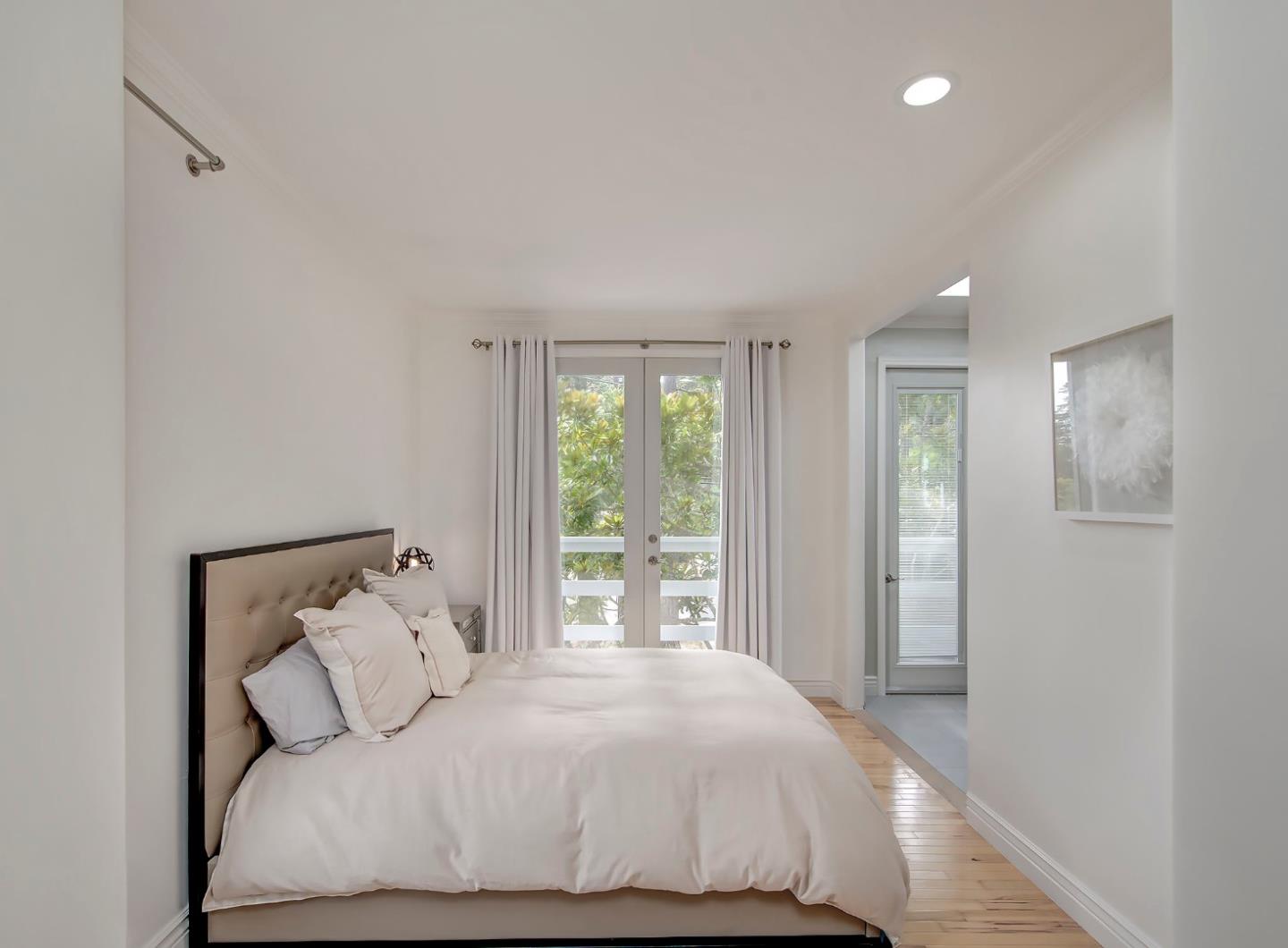 4143 Crest Road Pebble Beach, CA 93953 - Photo 13 of 20 a bedroom with a large bed and a window