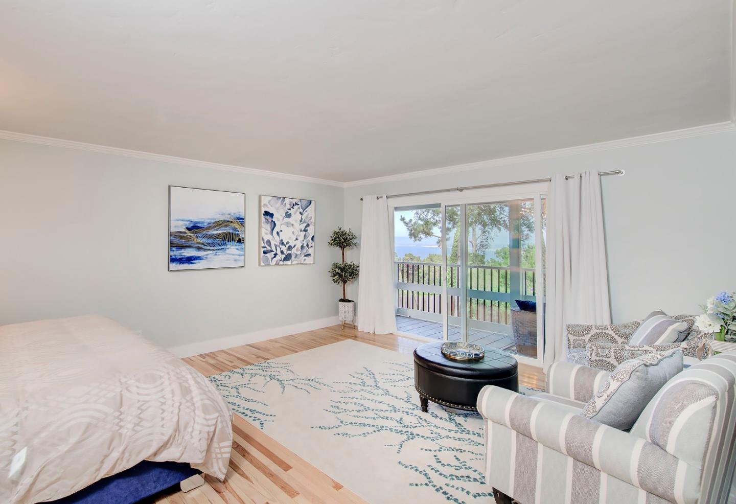 4143 Crest Road Pebble Beach, CA 93953 - Photo 8 of 20 a bedroom with a bed and wooden floor